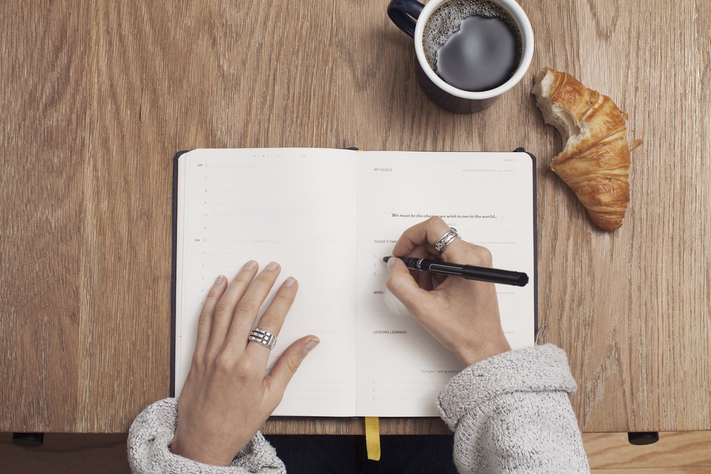 Learner writing notes beside a study planner
